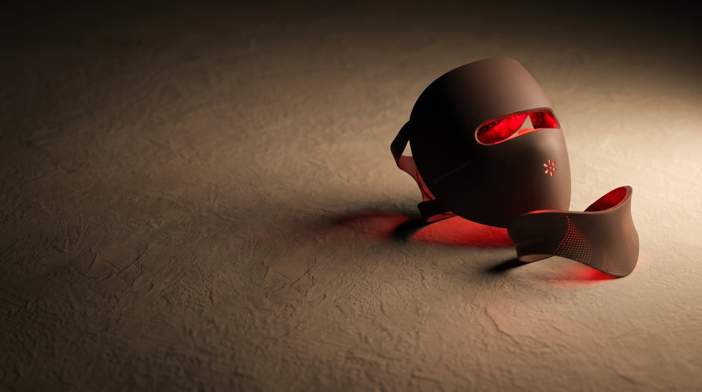 The Elysia mask and collar upright on pale plaster, lit red from inside.